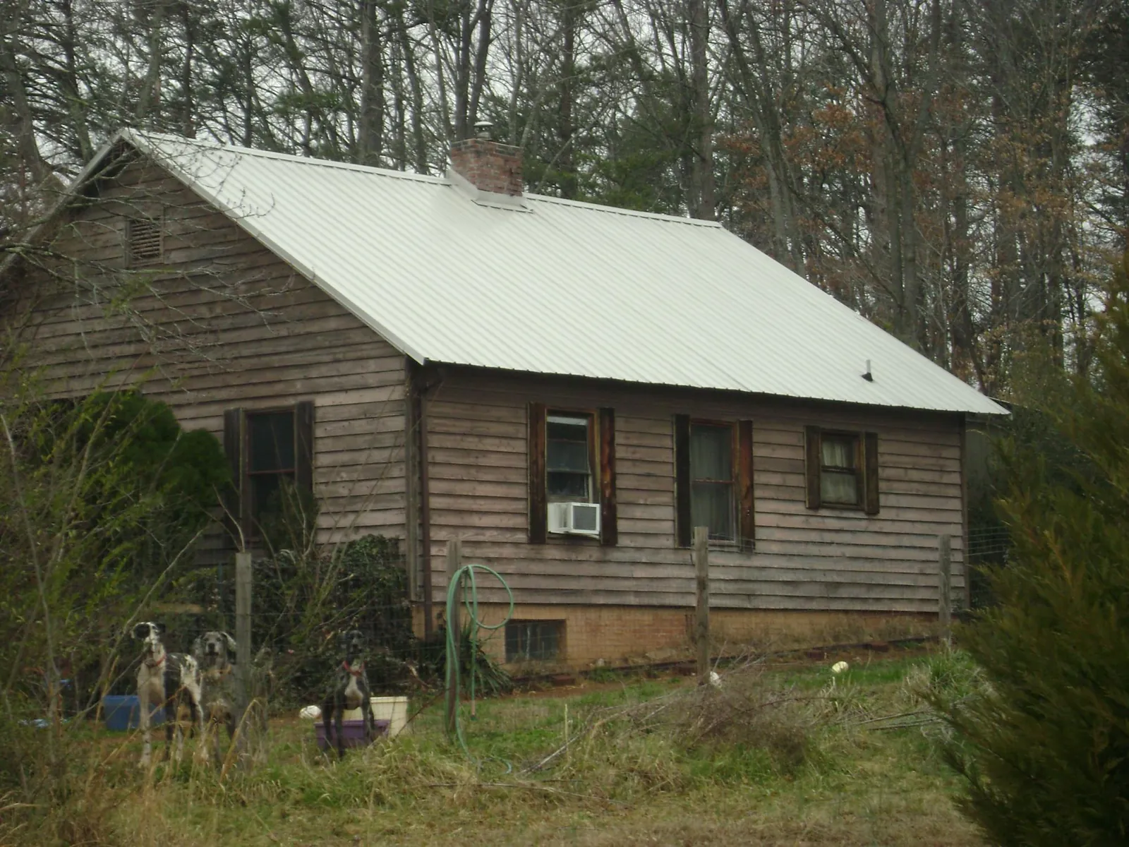 White metal roof on an old wood sided farmhouse, from a Metal Roof Installation job in Chula